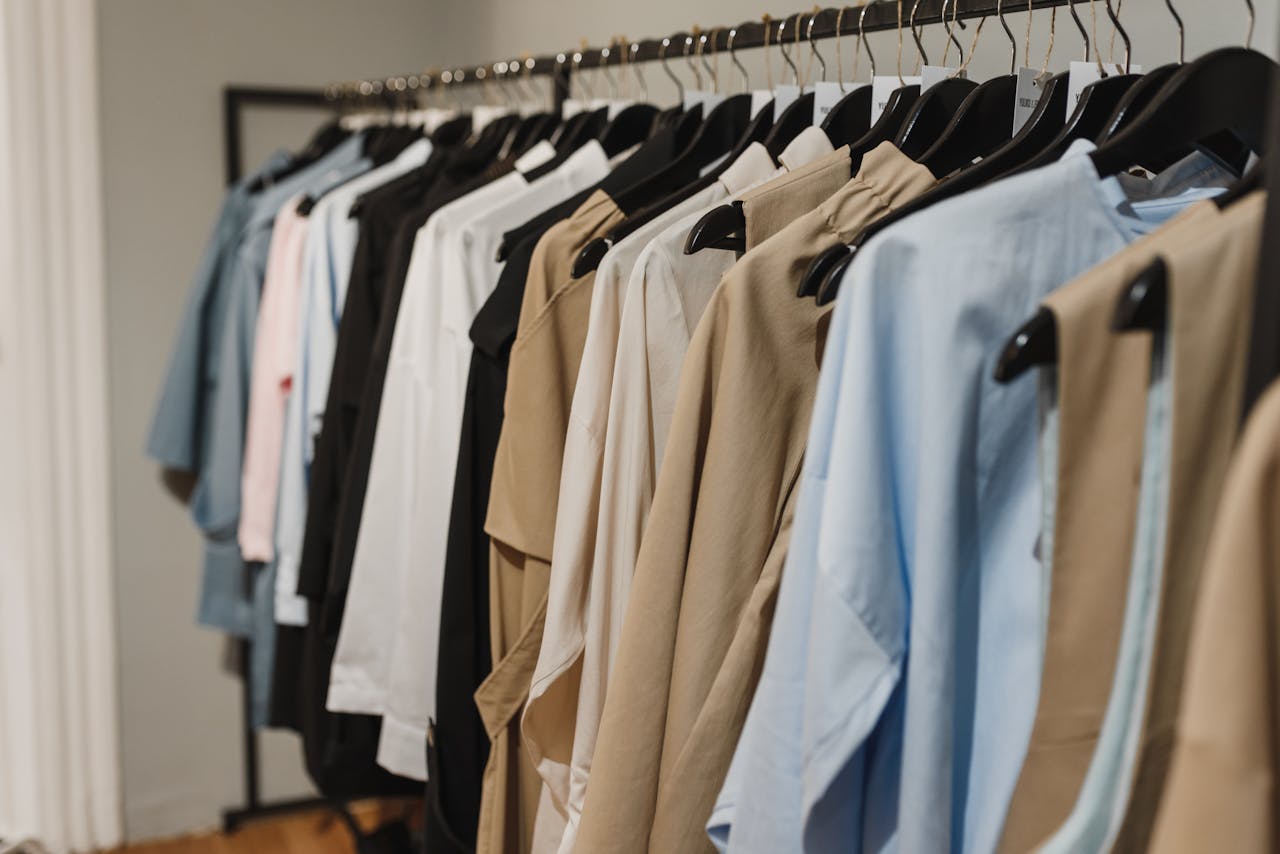 Services Stylish clothes hanging on a rack, showcasing a variety of elegant fashion pieces.